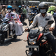 Commuters riding scooters in an Indian city.